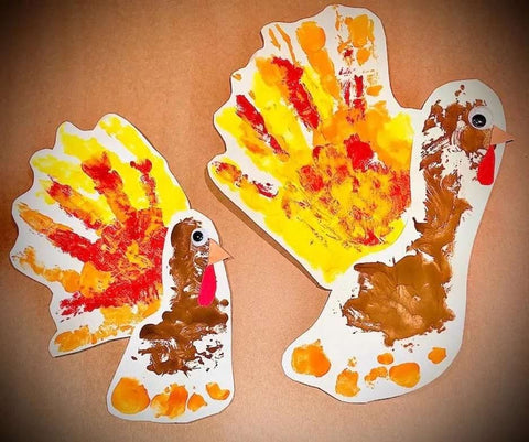 Turkeys made with foot and handprints for a baby's first Thanksgiving