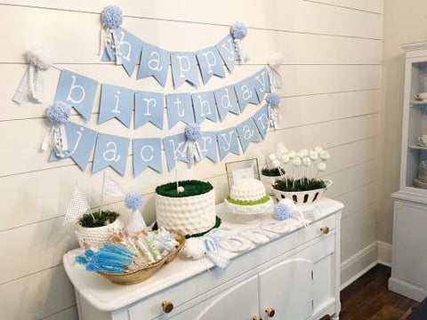 Banner reading “happy birthday Jack Ryan” hung over a buffet with a golf-themed birthday cake and other golf-themed treats.