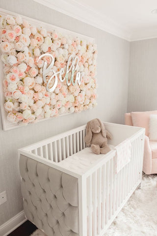 A floral nursery that features a 3-d fake flower display above the crib