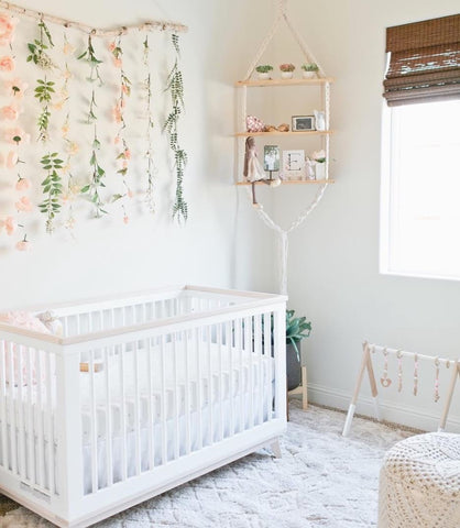 A white floral nursery featuring natural materials