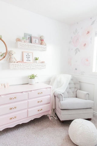Floral nursery decorated with soft-pink wallpaper and accents