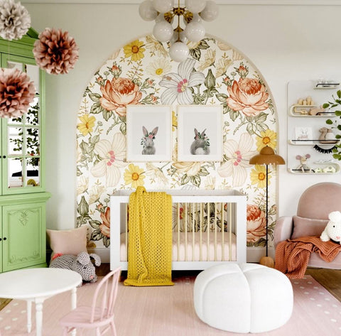 A floral nursery that features bright, vintage flower wallpaper