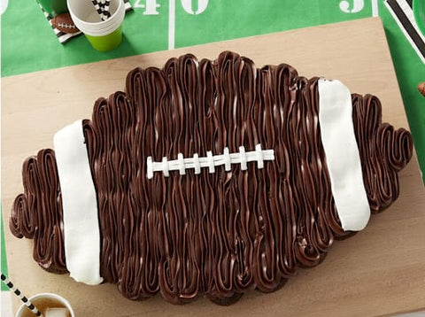 Chocolate frosted cupcake cake that looks like a football for a fall baby shower
