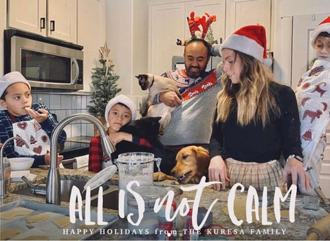 A holiday card photo that features a chaotic-looking kitchen scene