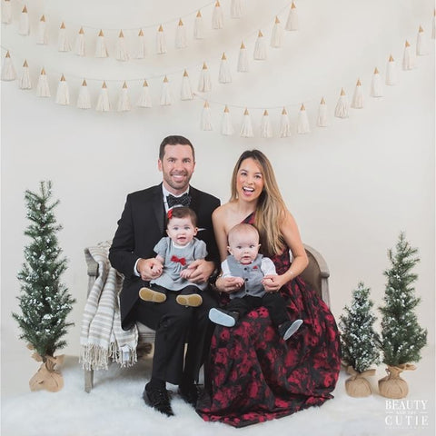 A family poses in formal attire for a holiday card photo