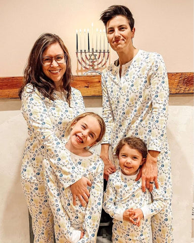 A family poses in Hanukkah pjs for a holiday card photo