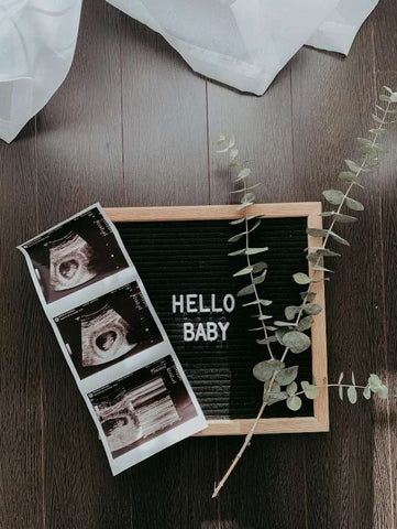 Letterboard pregnancy announcement that says "Hello Baby"