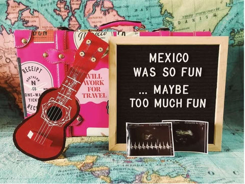 A funny, travel-themed letterboard pregnancy announcement