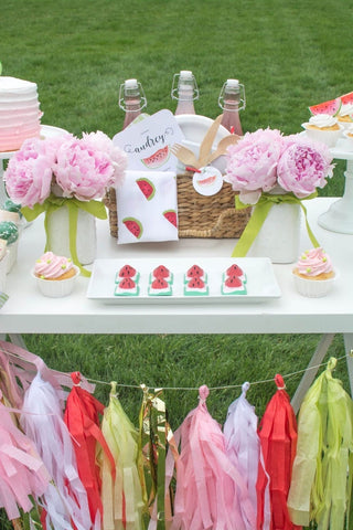 Table decorated for a watermelon-themed summer baby shower
