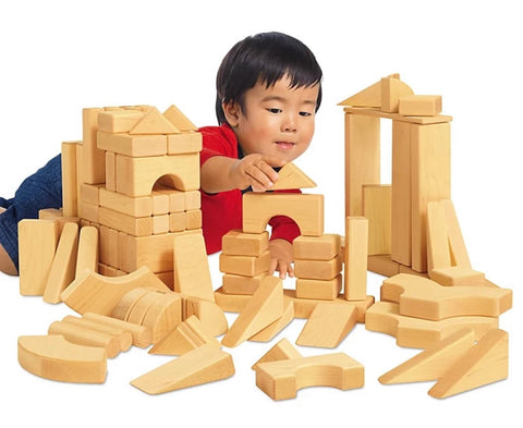 Toddler playing with wooden building blocks