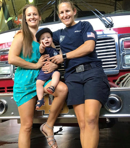 Morgan and Casey Dresser: Two moms holding child at firehouse