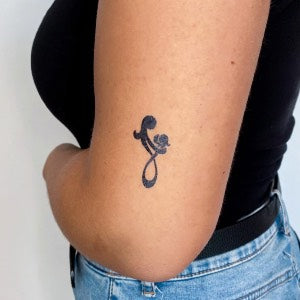 Tattoo ideas for parents: mother and child symbol tattoo