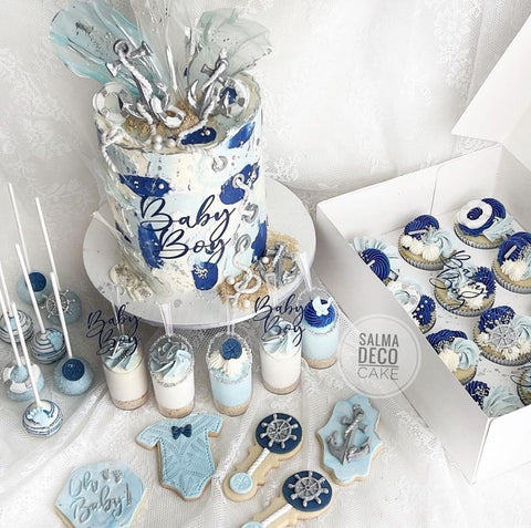 Nautical-themed baby shower cake, cupcakes, and other treats