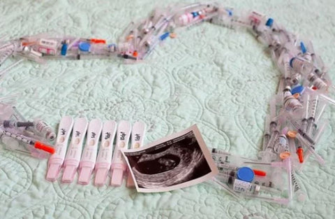 Needles arranged in a heart to announce IVF pregnancy