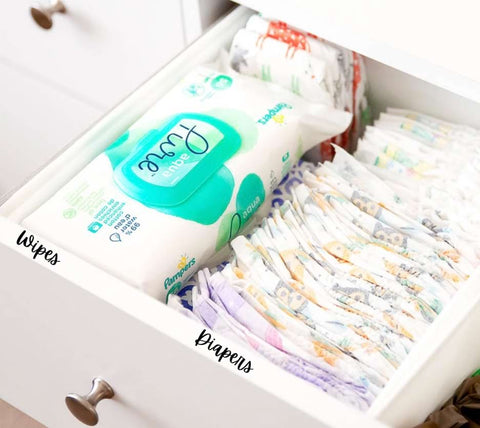 Diaper and wipe drawer in a nursery closet organized with labels