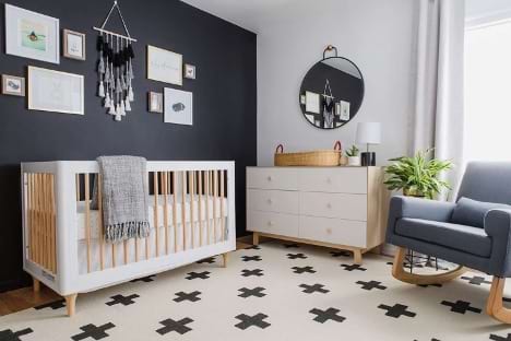 A nursery layout with the crib next to the changing station