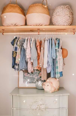 A nursery layout with the dresser in the closet
