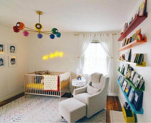 A brightly colored nursery with a colorful chandelier