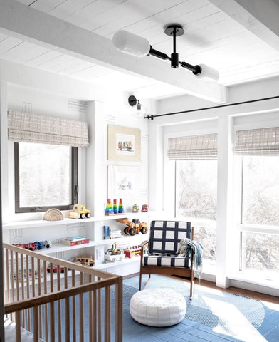 Industrial-style nursery lighting in a baby's room