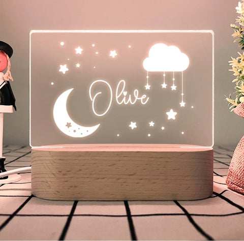 A lucite nursery nightlight that says "Olivia"
