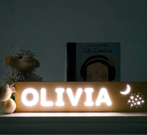 A personalized wooden nursery nightlight that says "Olivia"