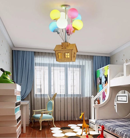 Nursery lighting fixture that looks like a house being lifted by balloons