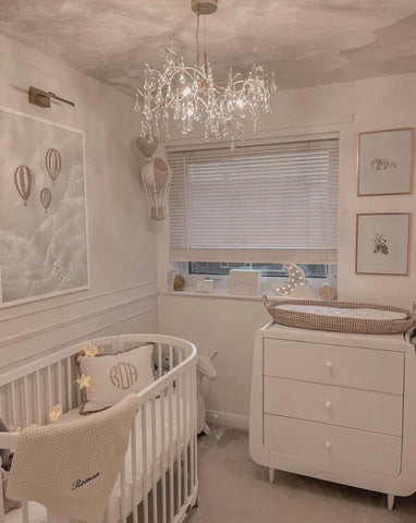 A nursery with a traditional chandelier for lighting