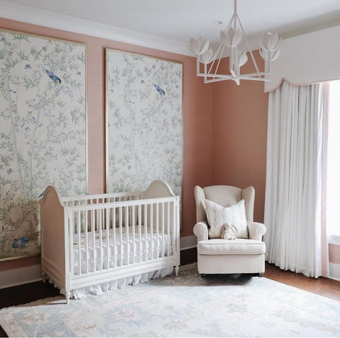 A vintage style chandelier in a baby's nursery