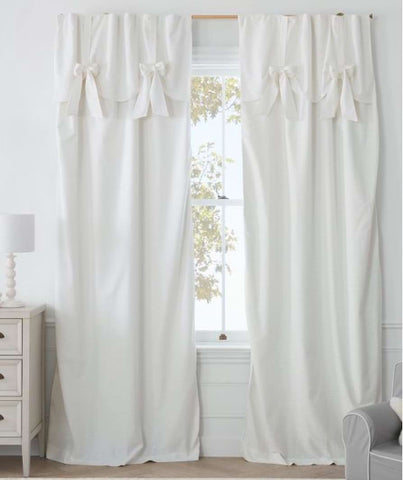 Long white drapes in a baby nursery