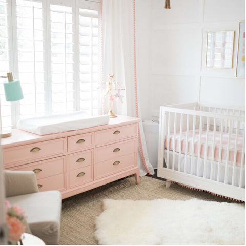 Pink painted dresser in a nursery