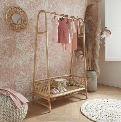 Bamboo standing clothing rack in a nursery