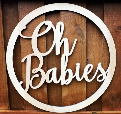 A carved wooden sign that says "Oh Babies"