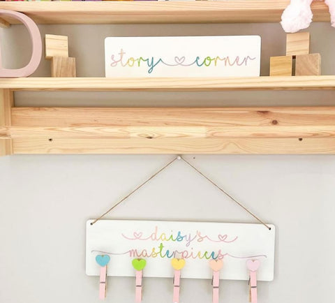 Personalized painted plaque with clothespins to display child's artwork