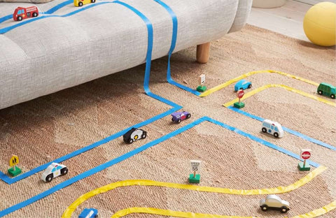 A car track made from painters tape for a toddler playdate