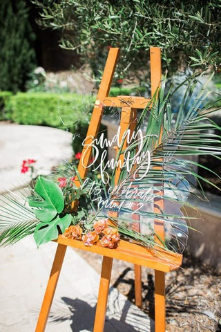 Hand-painted sign announcing a pool-themed summer baby shower