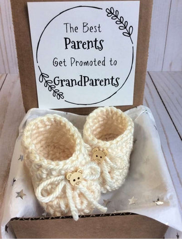 A box of baby booties used to announce a pregnancy