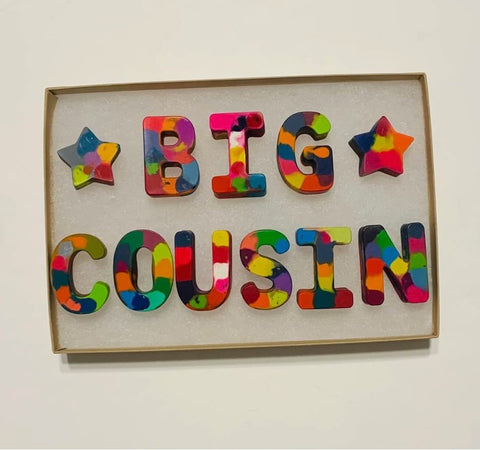 Crayons in the shape of the letters "BIG COUSIN" used to announce a pregnancy