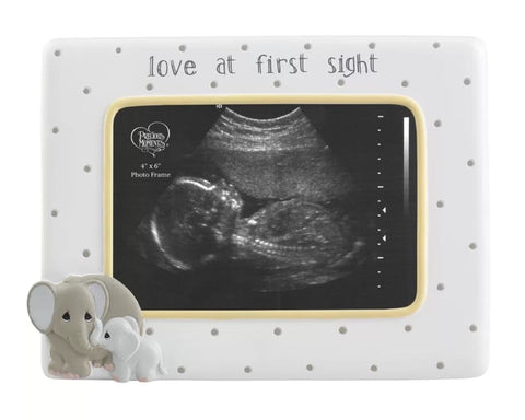 A baby ultrasound in a frame that says "love at first sight" used to announce a pregnancy