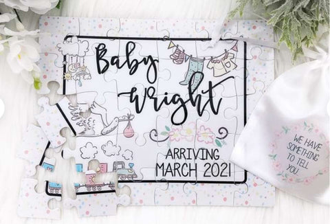 A jigsaw puzzle that says "Baby Wright Arriving March 2021"