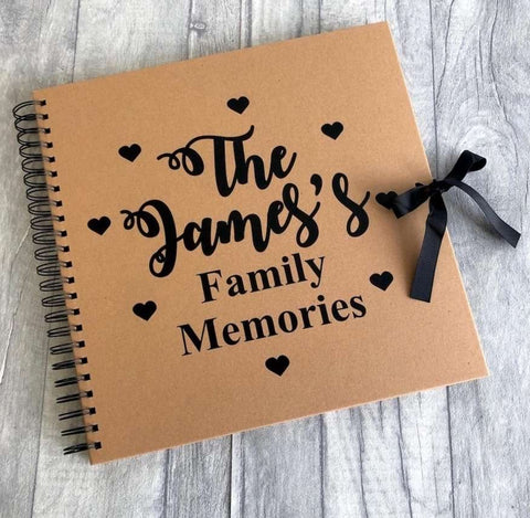 A scrapbook that says "The James's Family Memories" used in a pregnancy announcement