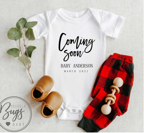 Pregnancy announcement onesie that says "Coming Soon"