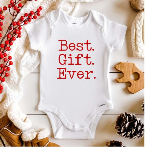 Holiday pregnancy announcement onesie that says "Best. Gift. Ever."