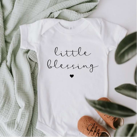 Pregnancy announcement onesie that says "little blessing" in script