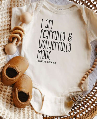 Pregnancy announcement onesie that says "I am fearfully and wonderfully made"