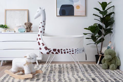 SNOO Zoo giraffe accessory in a safari-themed nursery