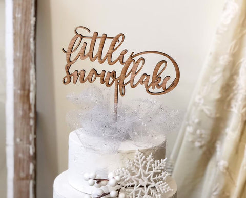 Snowflake-themed winter baby shower cake-topper