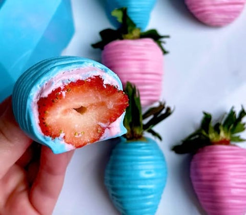 Pink and blue chocolate-covered strawberries.