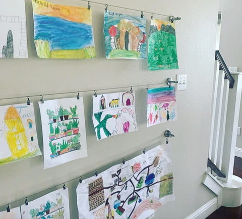 Kids art displayed on wire clothesline