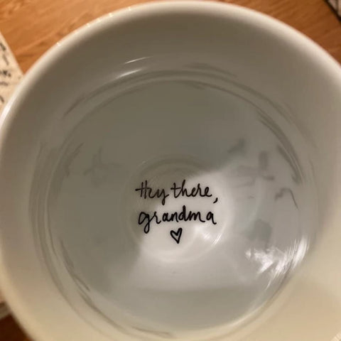 Bottom of coffee mug that says "hey there, grandma"