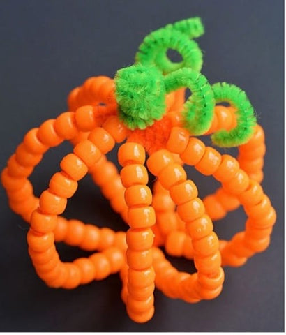 A Thanksgiving craft: A pumpkin made with beads and pipecleaners